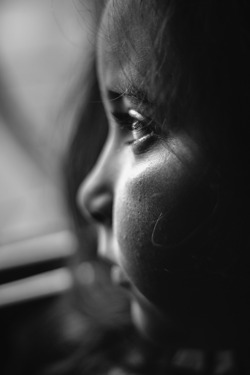 Black and white photograph of a sad and worried female child